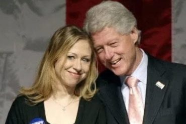 Bill Clinton smiles with woman at political event wearing Hillary campaign button