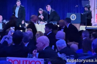 Trump addresses crowd at White House Correspondents Dinner event with presidential seal visible on podium