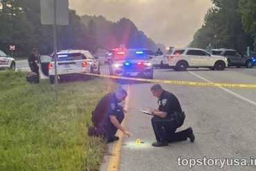 Police officers investigate a police high-risk zone on a highway with multiple emergency vehicles and crime scene tape