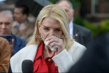 Woman in red blouse and white blazer speaking at podium about Florida confirmation reform during outdoor political event