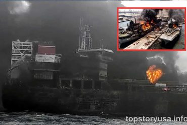 Military cargo ship engulfed in flames and smoke during combat strike, showing explosion on vessel deck